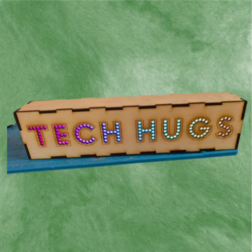A laser-cut LED box with lit lettering on the front